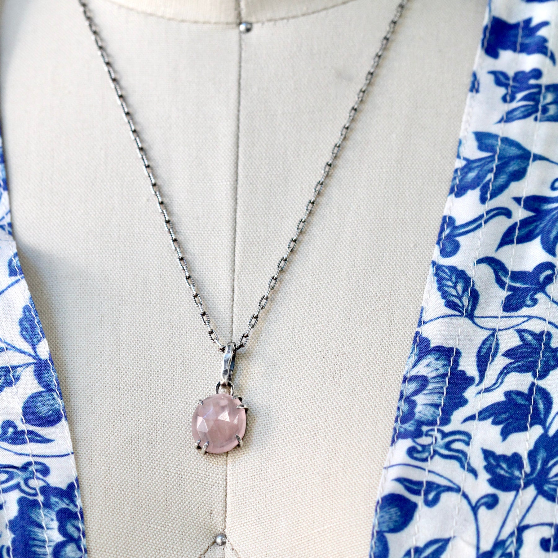 Rose cut Rose Quartz prong set in sterling silver with heart detail